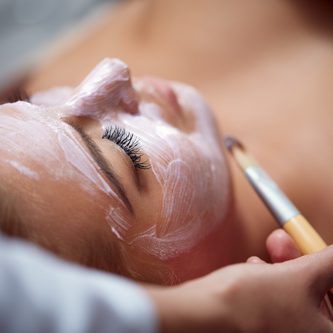 Beautiful young woman having a facial cosmetic treatment.